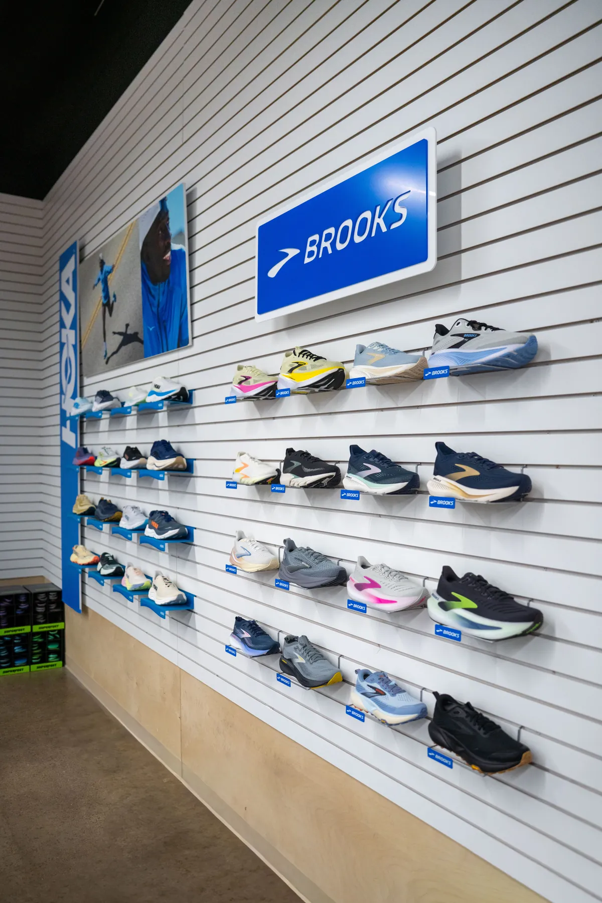 The Brooks wall at UtahRUN, cushioned running and walking shoes on white slatwall