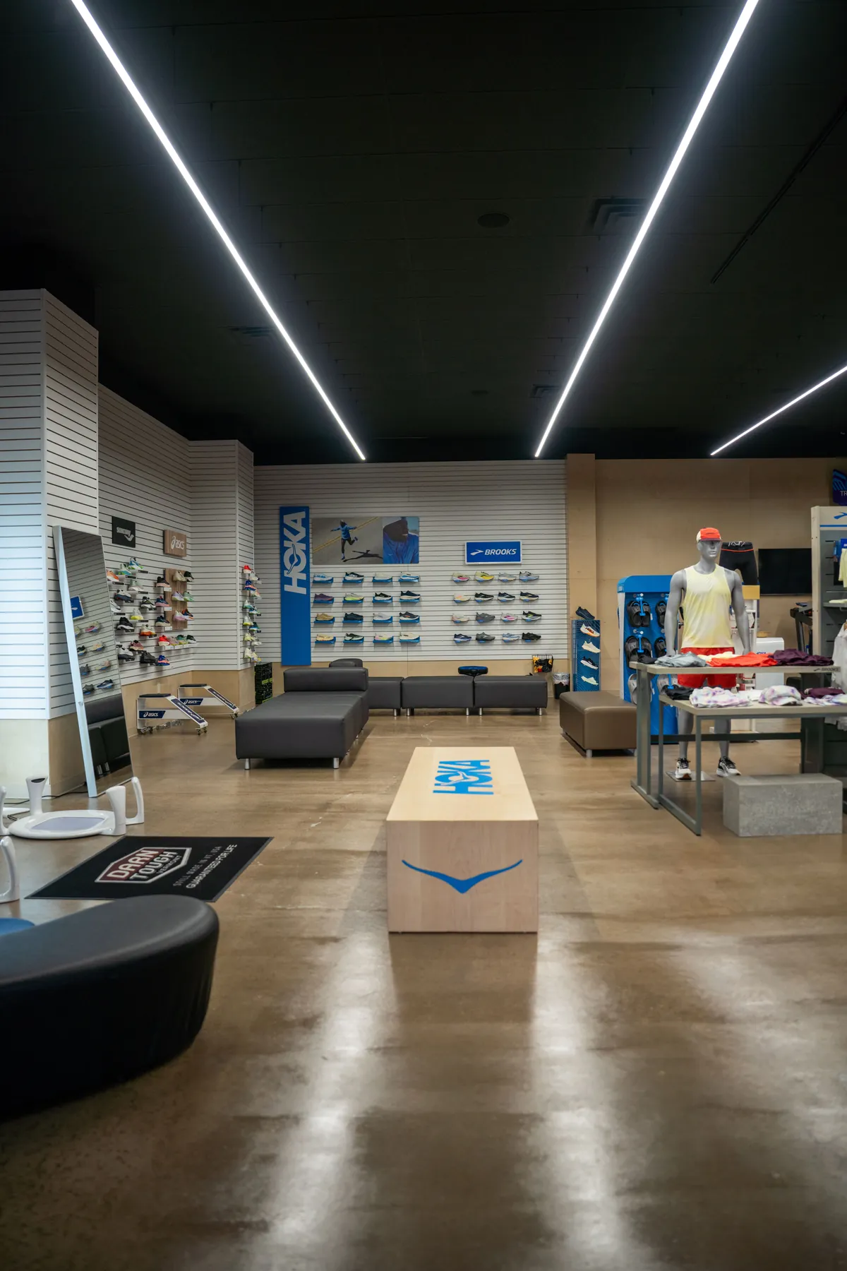 The fitting floor inside UtahRUN Lindon, a HOKA-branded platform running between the try-on seats