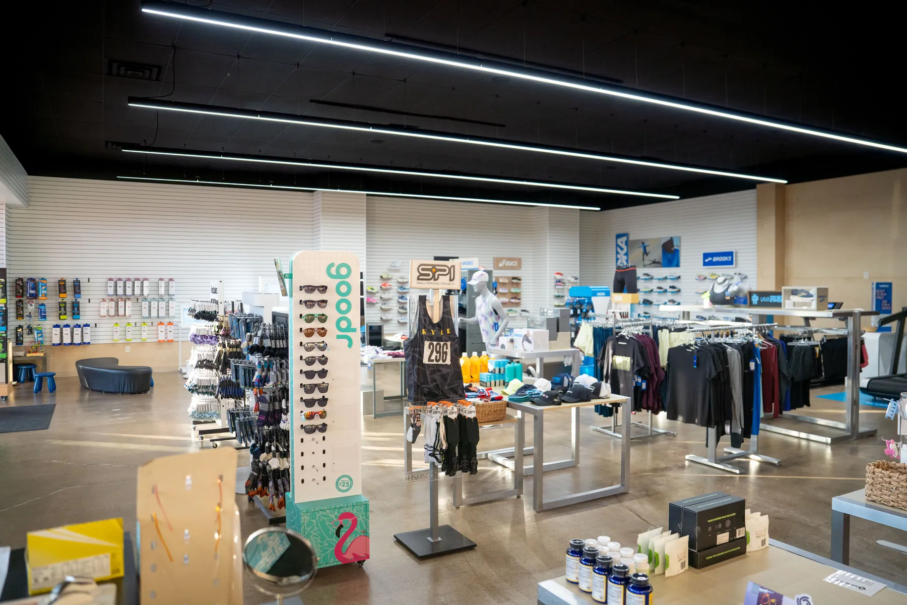 The UtahRUN sales floor, apparel racks and shoe displays under strip lighting