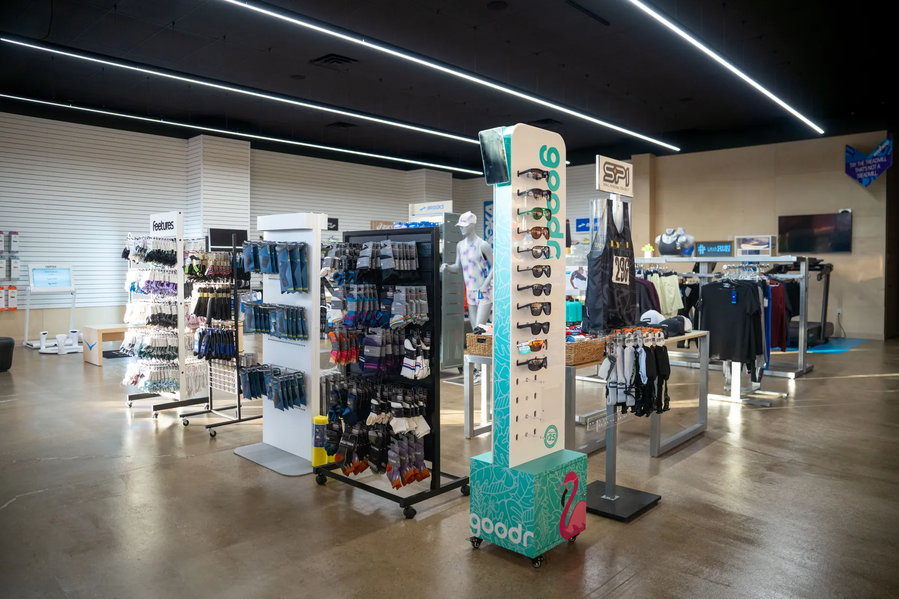 Inside the UtahRUN store in Lindon, shoe displays and seating under long strip lights