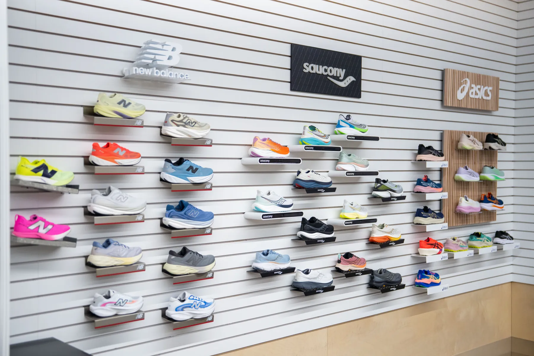An angled view of the Saucony and ASICS shoe wall at UtahRUN