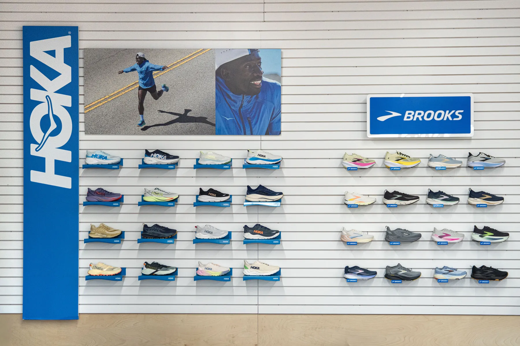 The HOKA and Brooks shoe wall at UtahRUN, rows of running shoes on white slatwall